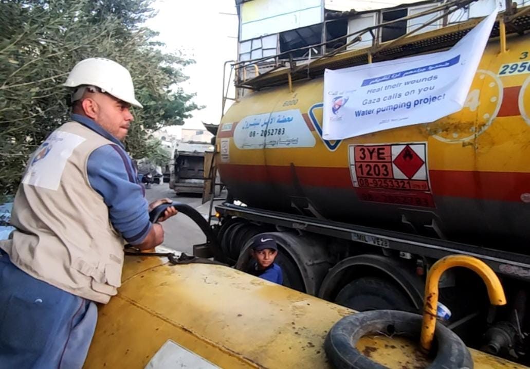 A Call of Hope volunteer filling from a water tanker in Gaza